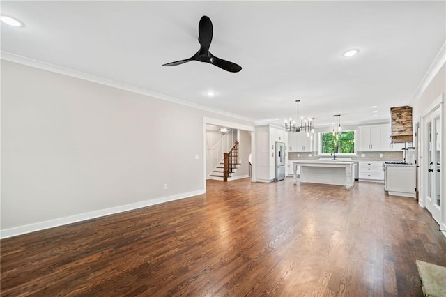 4189 Tamarack Dr, Jasper, GA 30143 - unfurnished living room with crown molding, stairs, ceiling fan, a chandelier, and baseboards