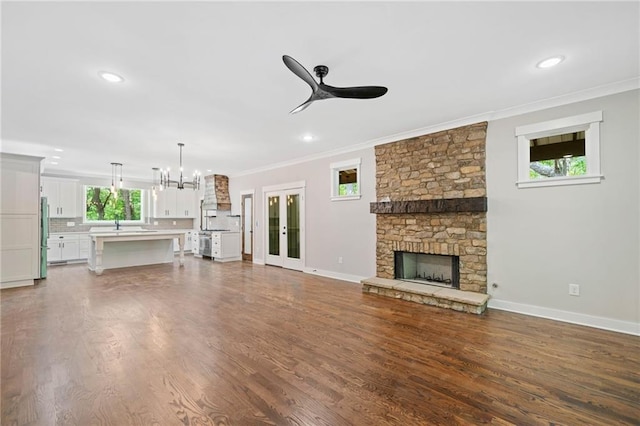 4189 Tamarack Dr, Jasper, GA 30143 - unfurnished living room featuring ceiling fan, crown molding, a chandelier, a fireplace, and baseboards