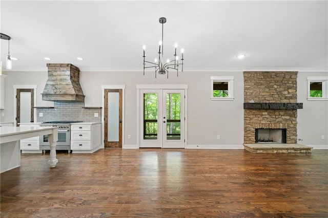 4189 Tamarack Dr, Jasper, GA 30143 - unfurnished living room with a fireplace, a chandelier, plenty of natural light, crown molding, and dark wood-style flooring
