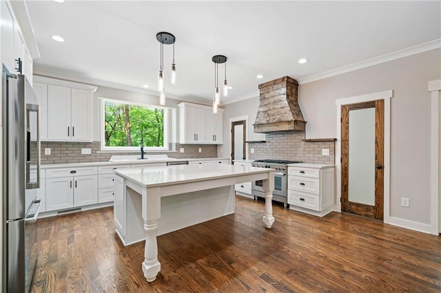 4189 Tamarack Dr, Jasper, GA 30143 - kitchen with stainless steel appliances, custom exhaust hood, crown molding, light countertops, and white cabinetry