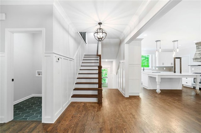 4189 Tamarack Dr, Jasper, GA 30143 - stairs featuring wood finished floors, a chandelier, and a decorative wall