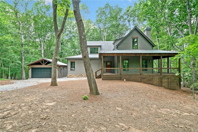4189 Tamarack Dr, Jasper, GA 30143 - view of front of house featuring a detached garage, an outbuilding, covered porch, a chimney, and metal roof