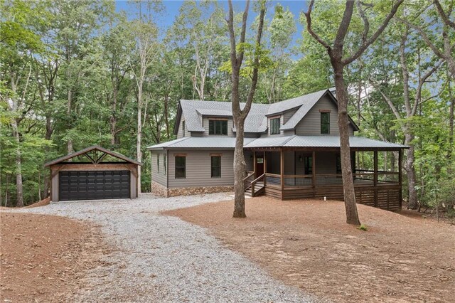 4189 Tamarack Dr, Jasper, GA 30143 - view of front facade featuring covered porch, an outdoor structure, gravel driveway, a detached garage, and metal roof