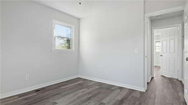 empty room featuring dark hardwood / wood-style floors