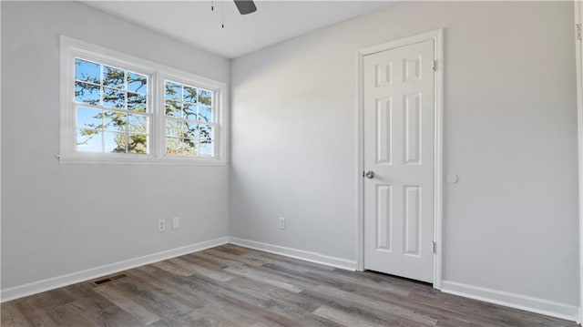 spare room featuring wood-type flooring and ceiling fan