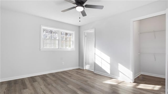 unfurnished bedroom with wood-type flooring, a closet, and ceiling fan