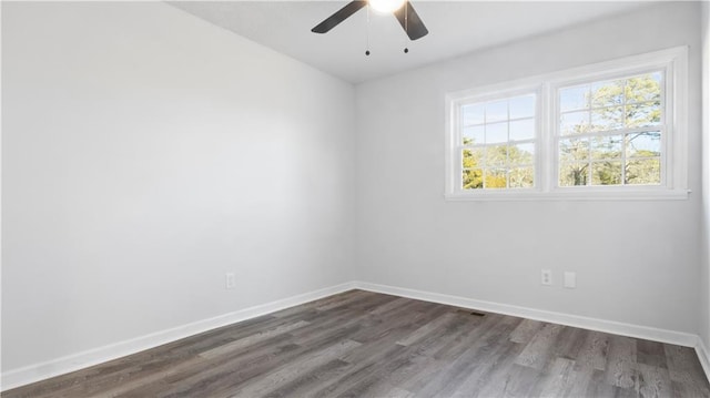 spare room with ceiling fan and dark wood-type flooring