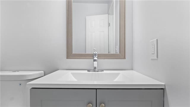 bathroom featuring toilet and vanity