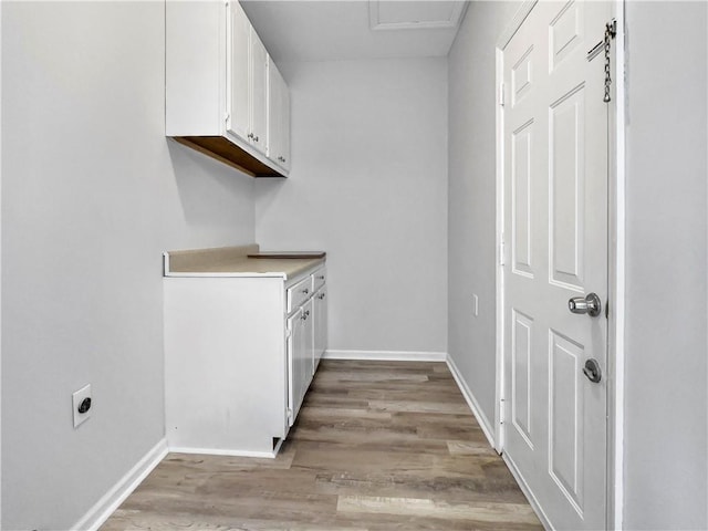 laundry room with light wood-type flooring, cabinets, and hookup for an electric dryer