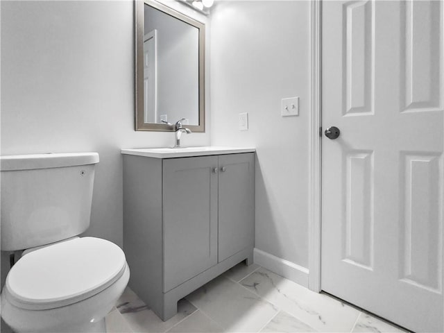 bathroom featuring toilet and vanity