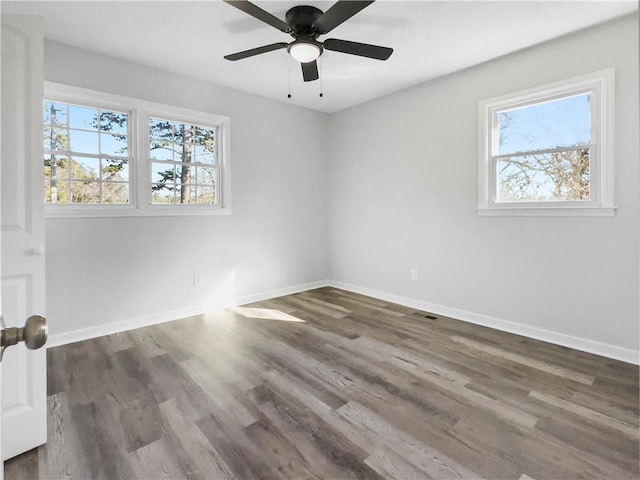 unfurnished room featuring dark wood-type flooring and ceiling fan