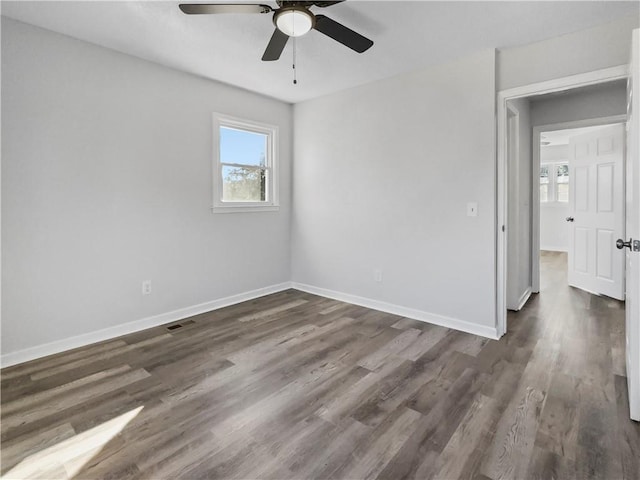 unfurnished room featuring ceiling fan and dark hardwood / wood-style flooring