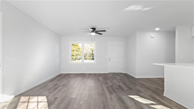 spare room with ceiling fan and dark hardwood / wood-style floors