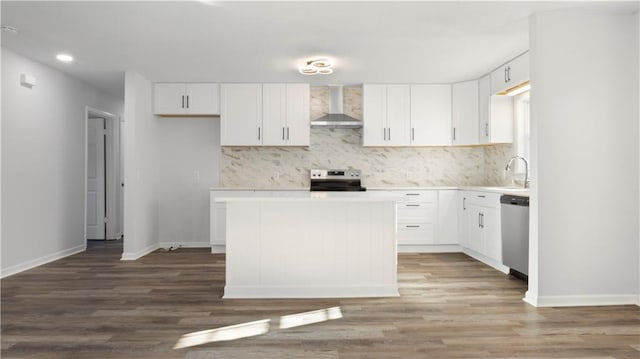 kitchen with stainless steel appliances, dark hardwood / wood-style floors, sink, white cabinetry, and wall chimney range hood