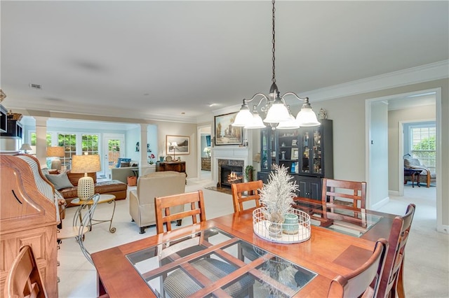 4460 Delano Dr, Cumming, GA 30040 - dining area featuring a chandelier, a high end fireplace, crown molding, and decorative columns