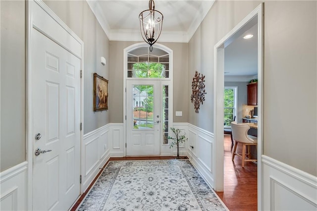 4460 Delano Dr, Cumming, GA 30040 - doorway to outside featuring ornamental molding, plenty of natural light, a decorative wall, wainscoting, and wood finished floors
