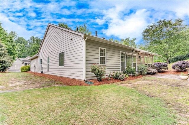 4460 Delano Dr, Cumming, GA 30040 - view of home's exterior featuring a yard