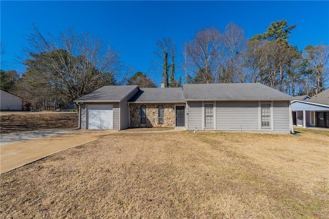 ranch-style house with a garage and a front lawn