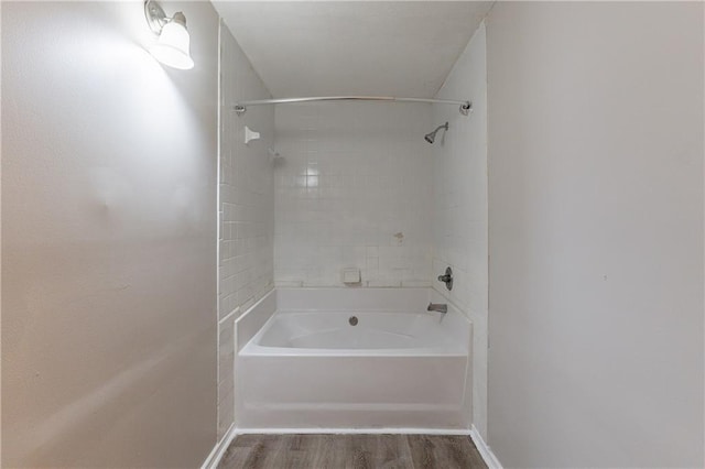 bathroom with tiled shower / bath and hardwood / wood-style floors