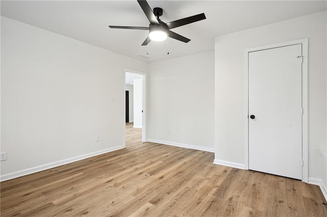 unfurnished bedroom with baseboards, wood finished floors, and a ceiling fan