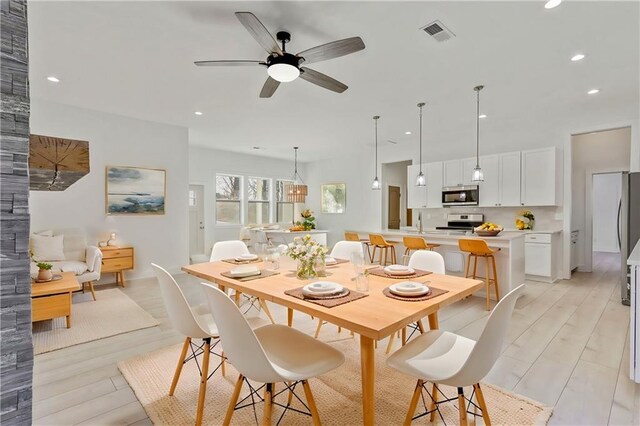 dining room with recessed lighting, visible vents, light wood finished floors, and ceiling fan