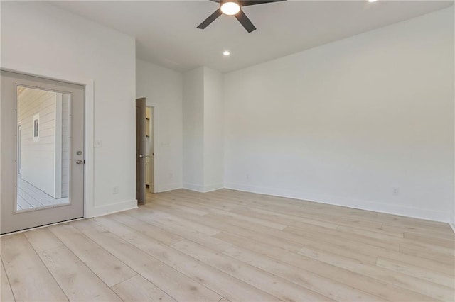 empty room with light wood-type flooring, baseboards, and a ceiling fan