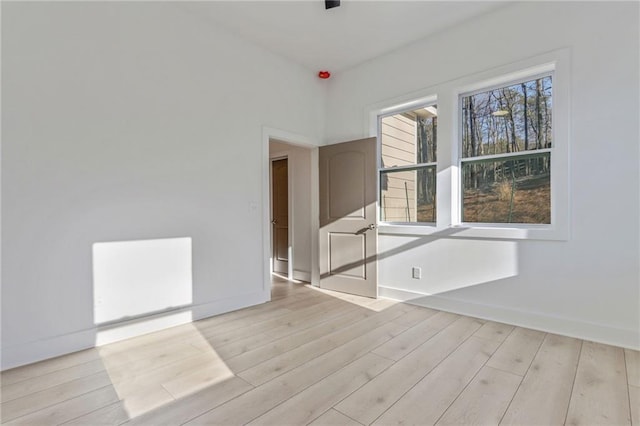 unfurnished room featuring baseboards and wood finished floors