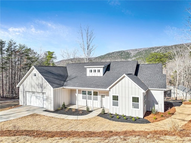 modern farmhouse style home with roof with shingles, board and batten siding, concrete driveway, and an attached garage