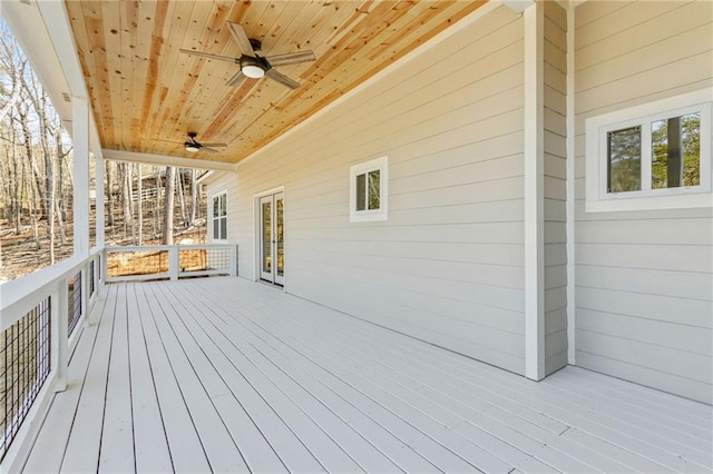 wooden deck featuring french doors and a ceiling fan