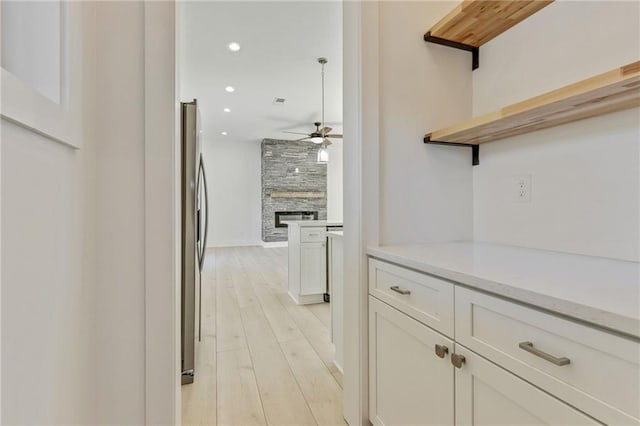 hallway featuring recessed lighting and light wood-style flooring