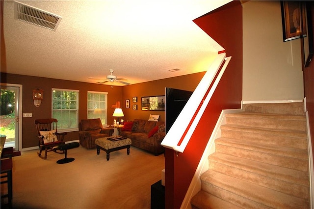 70 Darbys Crossing Ct, Hiram, GA 30141 - living area with a ceiling fan, stairway, a textured ceiling, and carpet flooring