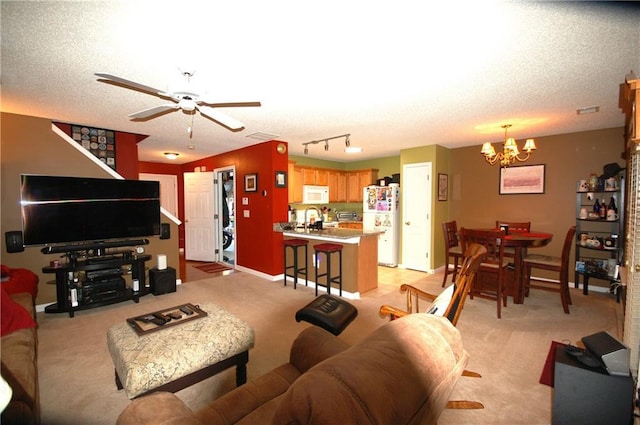 70 Darbys Crossing Ct, Hiram, GA 30141 - living room featuring a chandelier, a textured ceiling, ceiling fan, and light carpet