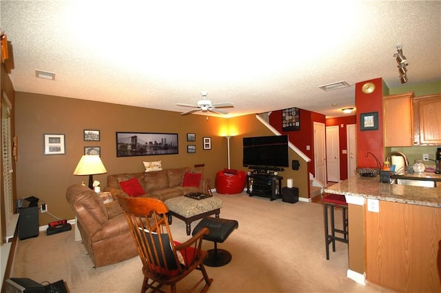 70 Darbys Crossing Ct, Hiram, GA 30141 - living room with light carpet, ceiling fan, baseboards, track lighting, and a textured ceiling