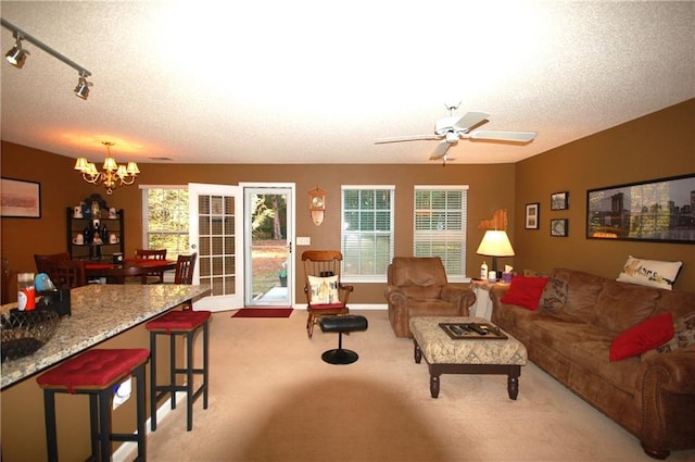70 Darbys Crossing Ct, Hiram, GA 30141 - living area with a chandelier, carpet, healthy amount of natural light, ceiling fan, and a textured ceiling