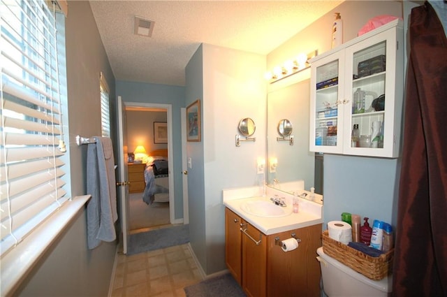 70 Darbys Crossing Ct, Hiram, GA 30141 - ensuite bathroom featuring vanity, a textured ceiling, and baseboards