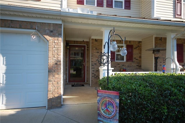 70 Darbys Crossing Ct, Hiram, GA 30141 - doorway to property featuring a garage, a porch, and brick siding