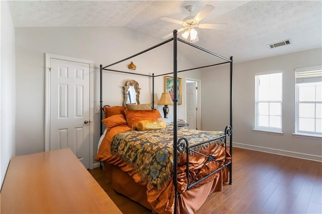 5351 Paramount View Way, Sugar Hill, GA 30518 - bedroom with vaulted ceiling, wood finished floors, a textured ceiling, and a ceiling fan