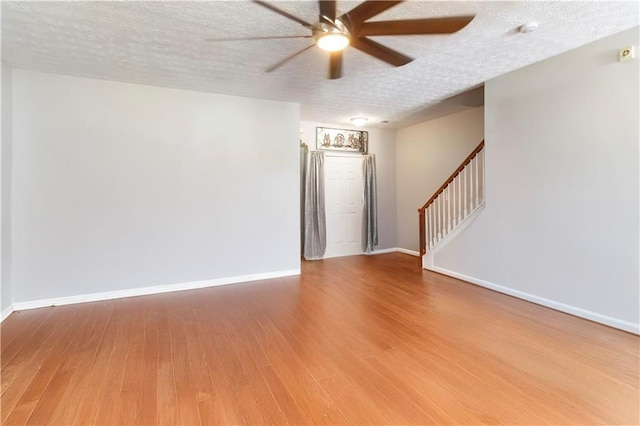 5351 Paramount View Way, Sugar Hill, GA 30518 - spare room with a ceiling fan, wood finished floors, a textured ceiling, stairway, and a smoke detector