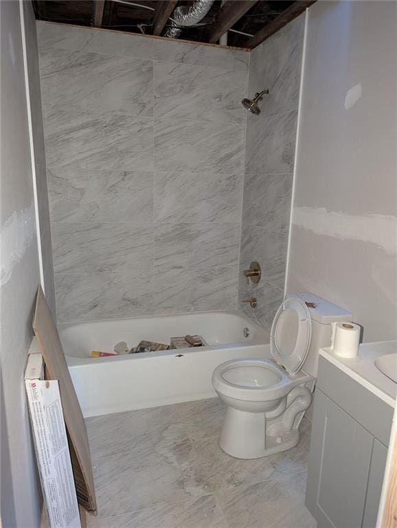 full bathroom featuring toilet, tiled shower / bath combo, and vanity