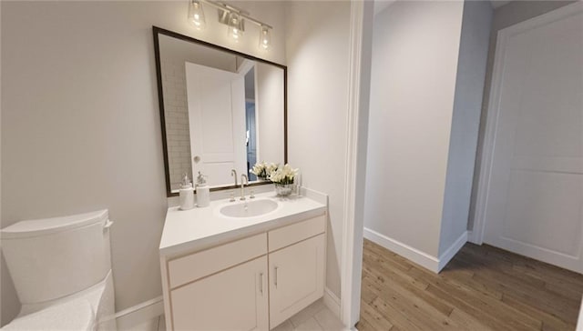 bathroom featuring vanity, toilet, and wood-type flooring