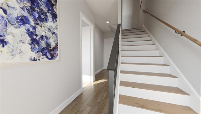 stairs with hardwood / wood-style flooring