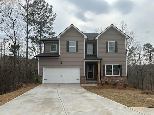 view of front facade featuring an attached garage, driveway, and brick siding