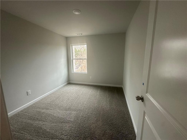 unfurnished room with carpet floors, baseboards, and visible vents