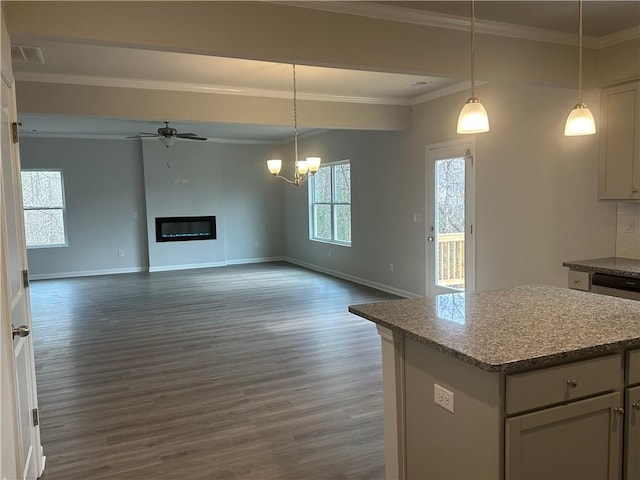 kitchen with visible vents, baseboards, open floor plan, dark wood-type flooring, and a center island