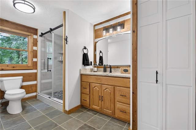 212 Dogpatch Ln, Blue Ridge, GA 30513 - bathroom featuring vanity, a stall shower, toilet, baseboards, and tile patterned flooring