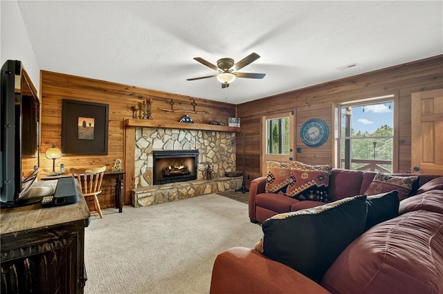 212 Dogpatch Ln, Blue Ridge, GA 30513 - living room with wood walls, a ceiling fan, carpet, and a fireplace