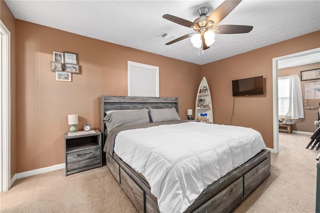 bedroom with visible vents, light carpet, a textured ceiling, baseboards, and ceiling fan