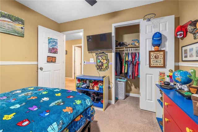 bedroom with light colored carpet, a closet, and baseboards