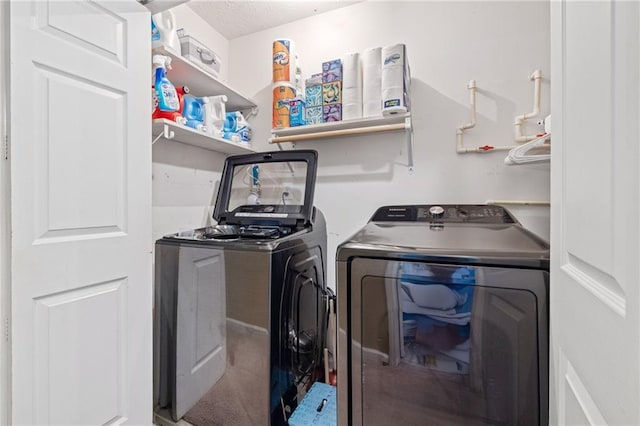 laundry room featuring laundry area, washer and dryer, and a textured ceiling