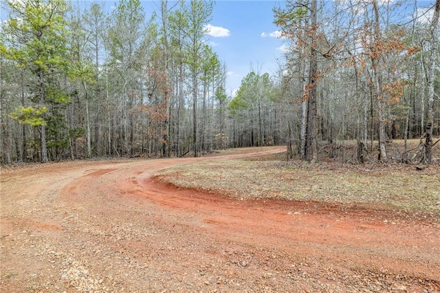 view of road featuring a wooded view